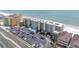 Aerial view of condo building with ocean views, pool, and parking in a beachfront location at 18650 Gulf Blvd # 203, Indian Shores, FL 33785