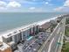 Aerial view of beachside condo with a pool and ocean views, close to a main road at 18650 Gulf Blvd # 203, Indian Shores, FL 33785