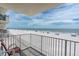 Balcony view of the beach with white railings and a blue sky at 18650 Gulf Blvd # 203, Indian Shores, FL 33785