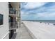 Balcony view overlooking a pristine beach with white sands and clear blue ocean waters at 18650 Gulf Blvd # 203, Indian Shores, FL 33785