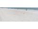 Expansive view of the white sandy beach, perfect for swimming, sunbathing, and relaxation at 18650 Gulf Blvd # 203, Indian Shores, FL 33785