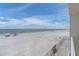 Serene beach view from the balcony, showcasing the ocean and sandy shoreline at 18650 Gulf Blvd # 203, Indian Shores, FL 33785