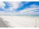 Expansive beach view with white sand and blue sky at 18650 Gulf Blvd # 203, Indian Shores, FL 33785
