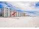 Condominium building on a white sand beach with a red arrow pointing to the location at 18650 Gulf Blvd # 203, Indian Shores, FL 33785