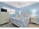 Well-lit bedroom features a bed, dresser, bedside tables, and laminate flooring at 18650 Gulf Blvd # 203, Indian Shores, FL 33785