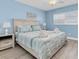 Comfortable bedroom with a queen bed, two nightstands, and bright blue walls at 18650 Gulf Blvd # 203, Indian Shores, FL 33785