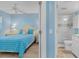 Bright, cozy bedroom with blue accents, featuring a comfortable bed and an en-suite bathroom with walk-in shower at 18650 Gulf Blvd # 203, Indian Shores, FL 33785
