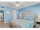 Comfortable bedroom with wood-look floors, a ceiling fan, and stylish coastal decor and furnishings at 18650 Gulf Blvd # 203, Indian Shores, FL 33785