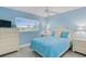 Charming bedroom with soft blue walls, cozy bedding, and ample natural light at 18650 Gulf Blvd # 203, Indian Shores, FL 33785