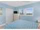 Comfortable bedroom with wood-look floors, a ceiling fan, and stylish coastal decor and furnishings at 18650 Gulf Blvd # 203, Indian Shores, FL 33785