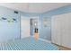Comfortable bedroom with wood-look floors, a ceiling fan, and stylish coastal decor and furnishings at 18650 Gulf Blvd # 203, Indian Shores, FL 33785