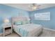 Comfortable bedroom with wood-look floors, a ceiling fan, and stylish coastal decor and furnishings at 18650 Gulf Blvd # 203, Indian Shores, FL 33785