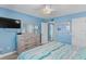Serene bedroom featuring a comfy bed, calming blue walls, and a large dresser for ample storage at 18650 Gulf Blvd # 203, Indian Shores, FL 33785