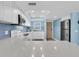 Clean kitchen featuring white cabinets, stainless steel appliances, blue accent tiles, and plenty of counter space at 18650 Gulf Blvd # 203, Indian Shores, FL 33785