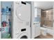 Laundry area featuring a stacked washer and dryer unit and small bath space with a shower at 18650 Gulf Blvd # 203, Indian Shores, FL 33785