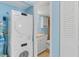 Convenient laundry area featuring a modern stacked washer and dryer, offering efficiency and space-saving design at 18650 Gulf Blvd # 203, Indian Shores, FL 33785