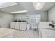 Bright laundry room featuring multiple machines and ample space for sorting and folding at 18650 Gulf Blvd # 203, Indian Shores, FL 33785