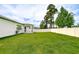 Spacious, well-kept backyard with green grass, privacy fence, and a covered patio for outdoor enjoyment at 18657 Obregan Dr, Spring Hill, FL 34610