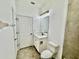 Compact bathroom with a white vanity, framed mirror, and toilet; linen storage out of view at 18657 Obregan Dr, Spring Hill, FL 34610