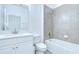Clean bathroom with modern white vanity, tiled shower and tub combination, and updated fixtures at 18657 Obregan Dr, Spring Hill, FL 34610