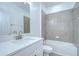 Modern bathroom with quartz countertop, tiled shower, and brushed nickel hardware at 18657 Obregan Dr, Spring Hill, FL 34610