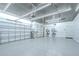 Well-lit, spacious garage with epoxy floors, offering ample storage and workspace for hobbies and vehicles at 18657 Obregan Dr, Spring Hill, FL 34610