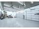 Spacious garage with epoxy floors, custom lighting, and ample storage and workspace at 18657 Obregan Dr, Spring Hill, FL 34610