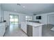 Open kitchen with stainless steel appliances, a large island, and seamless access to the outdoor area at 18657 Obregan Dr, Spring Hill, FL 34610