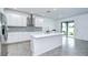 Bright kitchen with a white island, stainless steel appliances, modern cabinets and backyard views at 18657 Obregan Dr, Spring Hill, FL 34610