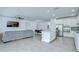 Open-concept kitchen and living room area with stainless steel appliances and tile floors at 18657 Obregan Dr, Spring Hill, FL 34610