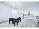 Bright living room featuring tile floors, modern lighting, and an open layout flowing to the kitchen at 18657 Obregan Dr, Spring Hill, FL 34610