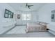 Bright main bedroom featuring a ceiling fan, modern floating nightstands, and artistic decor at 18657 Obregan Dr, Spring Hill, FL 34610