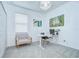 Bright office space featuring a modern desk, chair, and tranquil artwork, with ample natural light at 18657 Obregan Dr, Spring Hill, FL 34610
