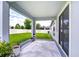 Inviting covered patio features stylish outdoor rug, plants, and peaceful backyard views at 18657 Obregan Dr, Spring Hill, FL 34610