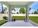 Covered patio area with a view of the expansive, well-maintained backyard and white privacy fence at 18657 Obregan Dr, Spring Hill, FL 34610