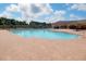 Beautiful community pool with brick pavers and lots of lounge chairs for relaxing in the sun at 18657 Obregan Dr, Spring Hill, FL 34610