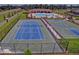 Community tennis and basketball courts with black metal fence for secure play at 18657 Obregan Dr, Spring Hill, FL 34610