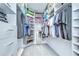 Well-organized walk-in closet with shelves, hanging rods, drawers, and a mirror, perfect for efficient storage at 18657 Obregan Dr, Spring Hill, FL 34610