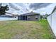 Spacious backyard featuring a screened-in patio, lush lawn, and privacy fencing, perfect for outdoor living at 1919 Oswego Dr, Holiday, FL 34691