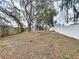 Large, fenced-in backyard with mature trees and landscaping at 1919 Oswego Dr, Holiday, FL 34691