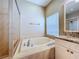 Bathroom with soaking tub, shower, and vanity with stone countertop at 1919 Oswego Dr, Holiday, FL 34691