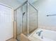 Bathroom with glass shower stall and soaking tub at 1919 Oswego Dr, Holiday, FL 34691
