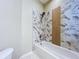 Modern bathroom featuring a tub with a stylish tile surround and a rainfall shower head at 1919 Oswego Dr, Holiday, FL 34691
