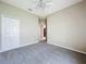 Cozy bedroom features neutral carpeting, ceiling fan, and a convenient closet at 1919 Oswego Dr, Holiday, FL 34691
