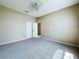 Bedroom featuring neutral carpeting, ceiling fan, and closet at 1919 Oswego Dr, Holiday, FL 34691