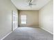 Clean bedroom with neutral paint, carpet, a ceiling fan, a double closet and a window for natural light at 1919 Oswego Dr, Holiday, FL 34691