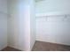 Spacious walk-in closet with wire shelving and neutral carpeting at 1919 Oswego Dr, Holiday, FL 34691