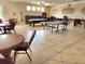 Spacious clubhouse featuring tables, chairs, pool table, ping pong table, and ample lighting at 1919 Oswego Dr, Holiday, FL 34691