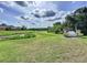 Scenic view of the Hidden Key community featuring a lush green lawn and community entrance sign at 1919 Oswego Dr, Holiday, FL 34691