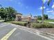 Stone community sign for Key Vista Gulf Trace with landscaping on a clear, sunny day at 1919 Oswego Dr, Holiday, FL 34691